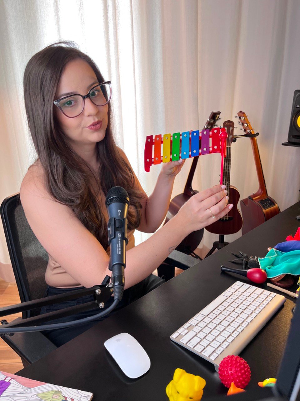 Isa gravando as aulas do MCI com microfone e metalofone colorido